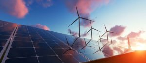 Solar panels and wind turbines at sunset